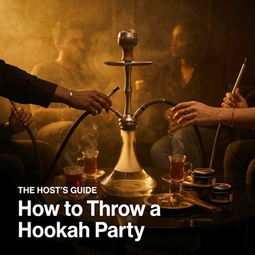 Friends gathered around a hookah reaching for the hoses, with glasses of tea, coals, and shisha tobacco tins on the table